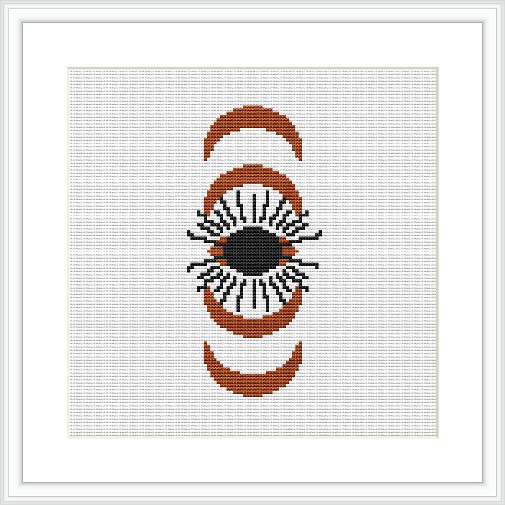 A cross stitch pattern featuring an eye framed by two crescent shapes on a white canvas. The design is composed of brown, beige, black, and orange colors.