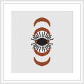 A cross stitch pattern featuring an eye framed by two crescent shapes on a white canvas. The design is composed of brown, beige, black, and orange colors.