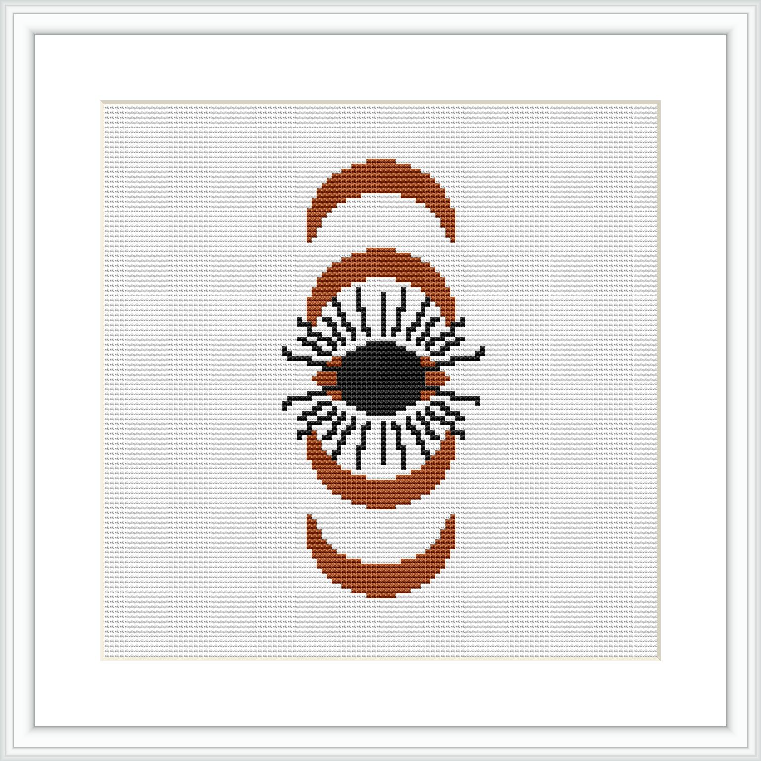 A cross stitch pattern featuring an eye framed by two crescent shapes on a white canvas. The design is composed of brown, beige, black, and orange colors.