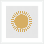 The picture shows a framed cross stitch pattern, placed against a white background. Centered on the canvas is a stylized sun with a solid round center in shades of yellow and gold, surrounded by rays represented by lines and geometric shapes.