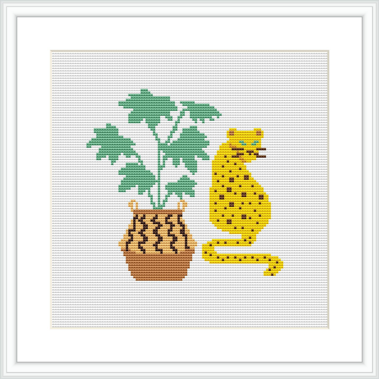 The image showcases a cross stitch pattern of a yellow and black spotted leopard sitting beside a potted plant with large green leaves. The plant is in a brown pot with decorative patterns.