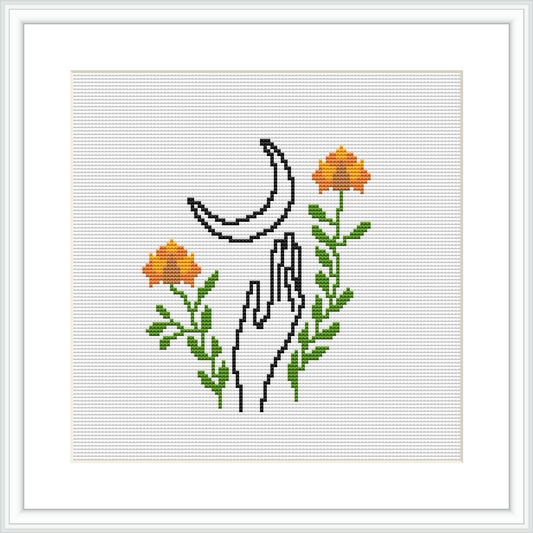 The image presents a cross stitch pattern featuring illustrated hands reaching towards a crescent moon, surrounded by leaves and blooming flowers.