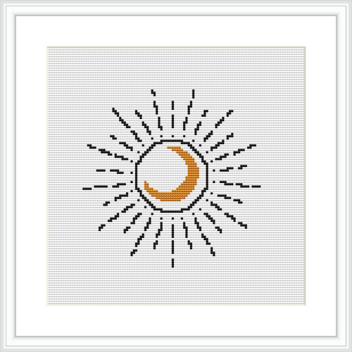 The image shows a framed cross stitch pattern of a stylized crescent moon with lines radiating outward to represent its glow, all stitched on a white canvas.