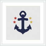 The image shows a cross stitch pattern of a navy blue anchor with three stars in red, yellow, and sky blue, framed in white on a white aida cloth.