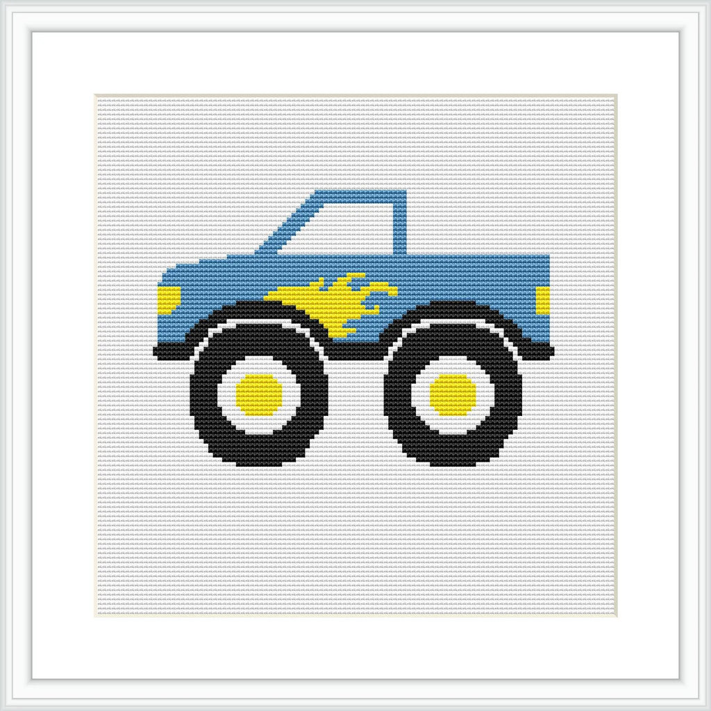 The image shows a stylized cross stitch pattern of a blue truck with large black wheels and small yellow and blue flames on the side. The truck is centered on a white background, enclosed in a square frame.