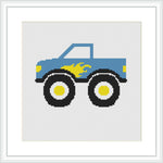 The image shows a stylized cross stitch pattern of a blue truck with large black wheels and small yellow and blue flames on the side. The truck is centered on a white background, enclosed in a square frame.