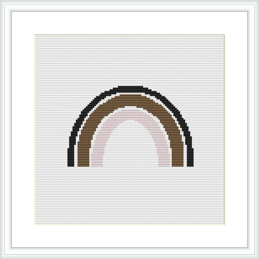 The image features a cross stitch pattern of an arch resembling a simplified rainbow. It consists of horizontal bands of different colors decreasing in width from the bottom to the top against a white background. It is framed within a simple white picture frame, giving it a clean, finished look.