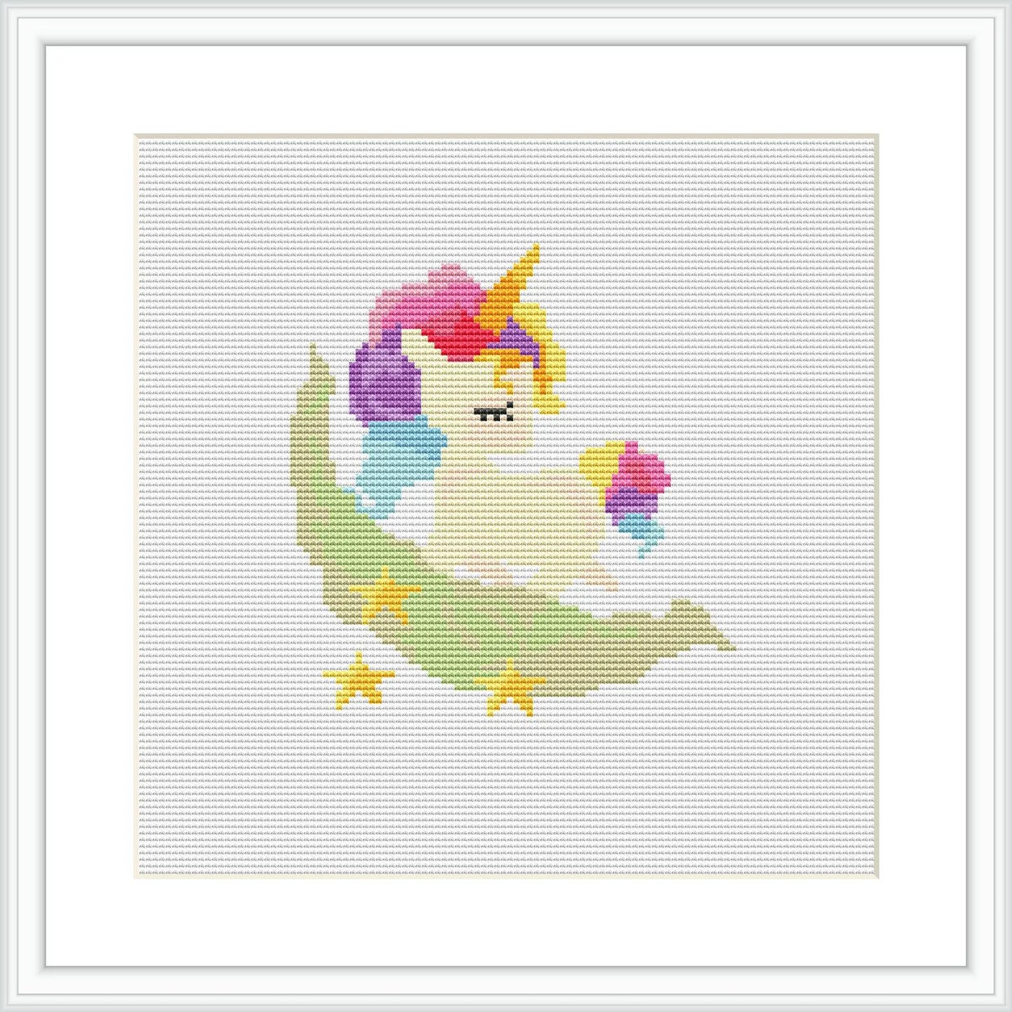 The cross stitch pattern depicts a stylized unicorn with a multicolored mane and tail, sitting on a crescent moon-like cloud. A small rainbow with stars around it is presented behind the unicorn. The embroidery is framed in a simple white frame with a white matte border.