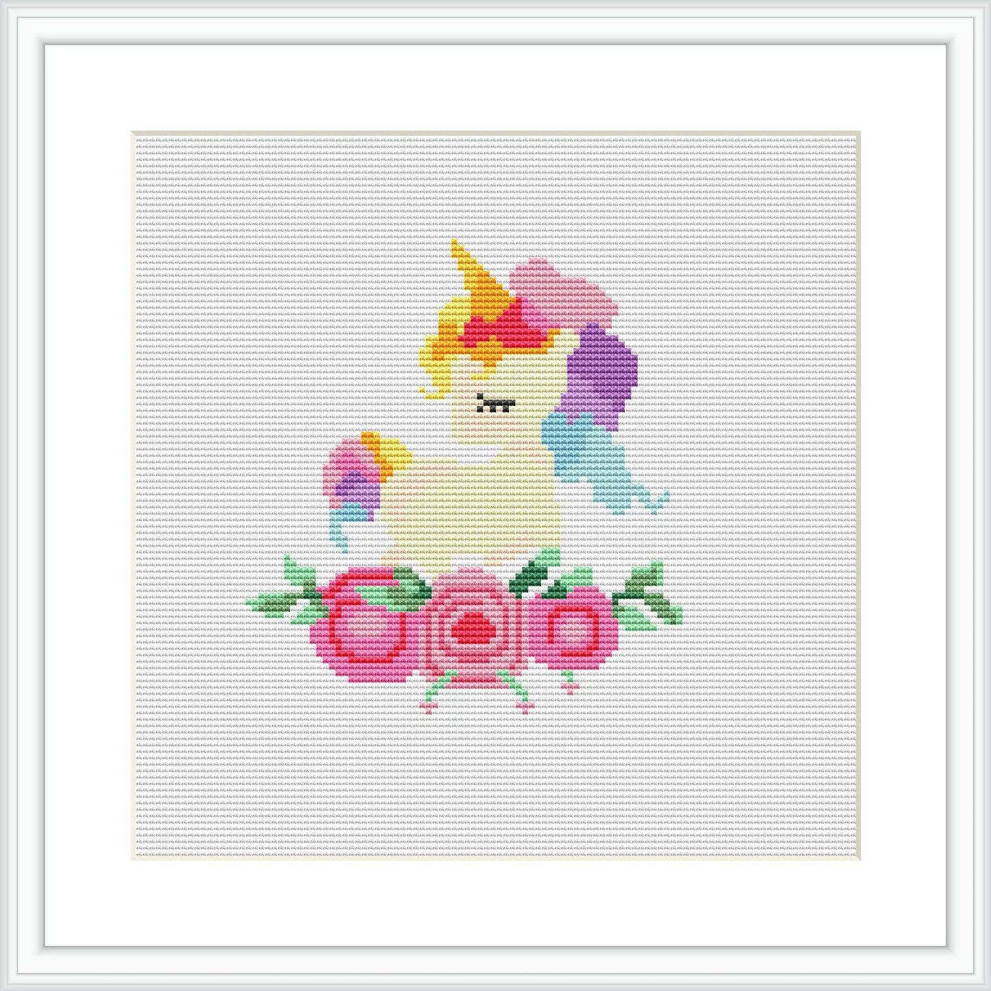 The image depicts a framed cross stitch pattern featuring a unicorn with a rainbow mane and tail, framed by flowers at the bottom.