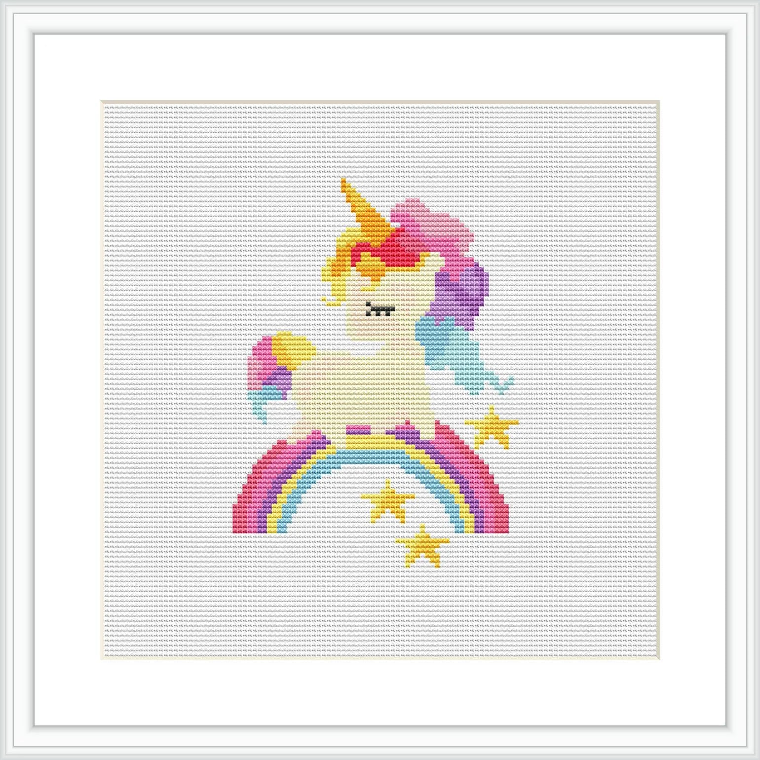 The image depicts a cross stitch pattern of a unicorn with a rainbow mane and tail seated on a curved rainbow. Below the rainbow are yellow stars sprinkled across a white background. The pattern is framed in a simple white frame.