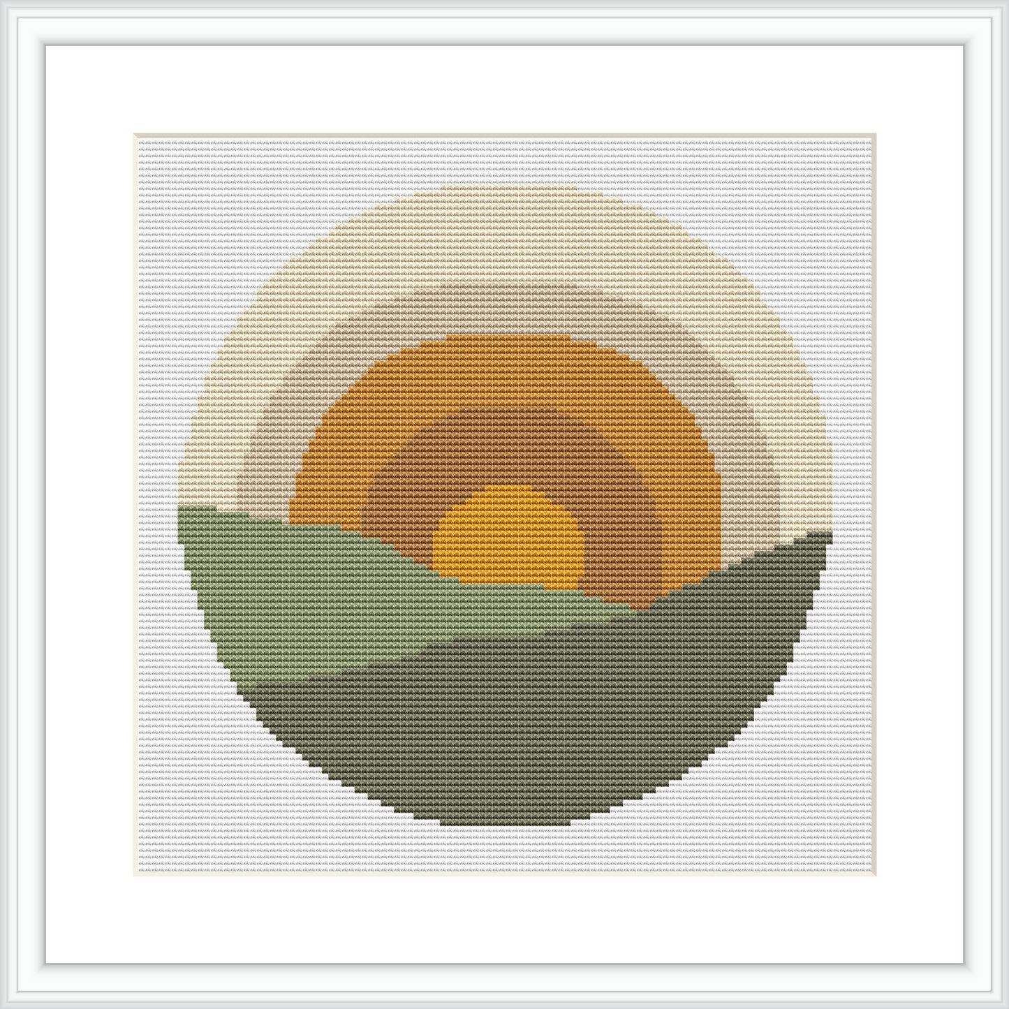 The image shows a cross stitch design featuring a stylized, simplistic sunrise with a yellow center, an orange ring around it, and a larger beige ring enclosing the orange. The bottom half depicts two green hills in a darker tone in front and a lighter tone in the back under a circular backdrop.