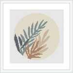 A cross stitch pattern featuring a collection of fern leaves in various shades of green and tan, arranged in a circular gradient on a cream-colored background, encased within a light frame.
