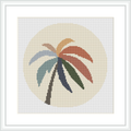 The image shows a framed cross stitch pattern featuring a stylized palm tree with multicolored fronds against a pale background, within a circular border.