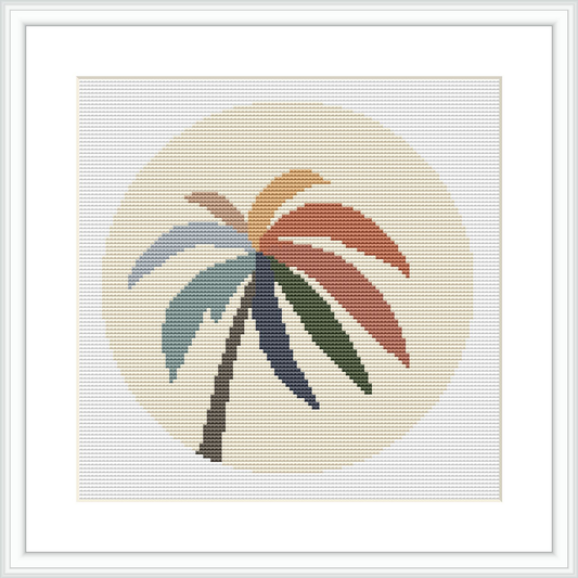 The image shows a framed cross stitch pattern featuring a stylized palm tree with multicolored fronds against a pale background, within a circular border.
