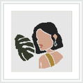 The image depicts a side profile of a woman with black hair, her face turned slightly downwards, and a large green tropical leaf partially obscuring her face. She wears a strapless top and an earring. The design is framed against a white background.