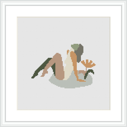 The image displays a framed cross-stitch pattern featuring an abstract representation of a woman sitting in a relaxed pose with a leaf-like pattern in the background.