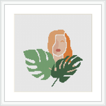 The image contains a stylized depiction of a woman's face and upper torso accompanied by tropical leaves. She appears to be overlaying or emerging from the foliage. The pattern is within a square frame, with a white background.
