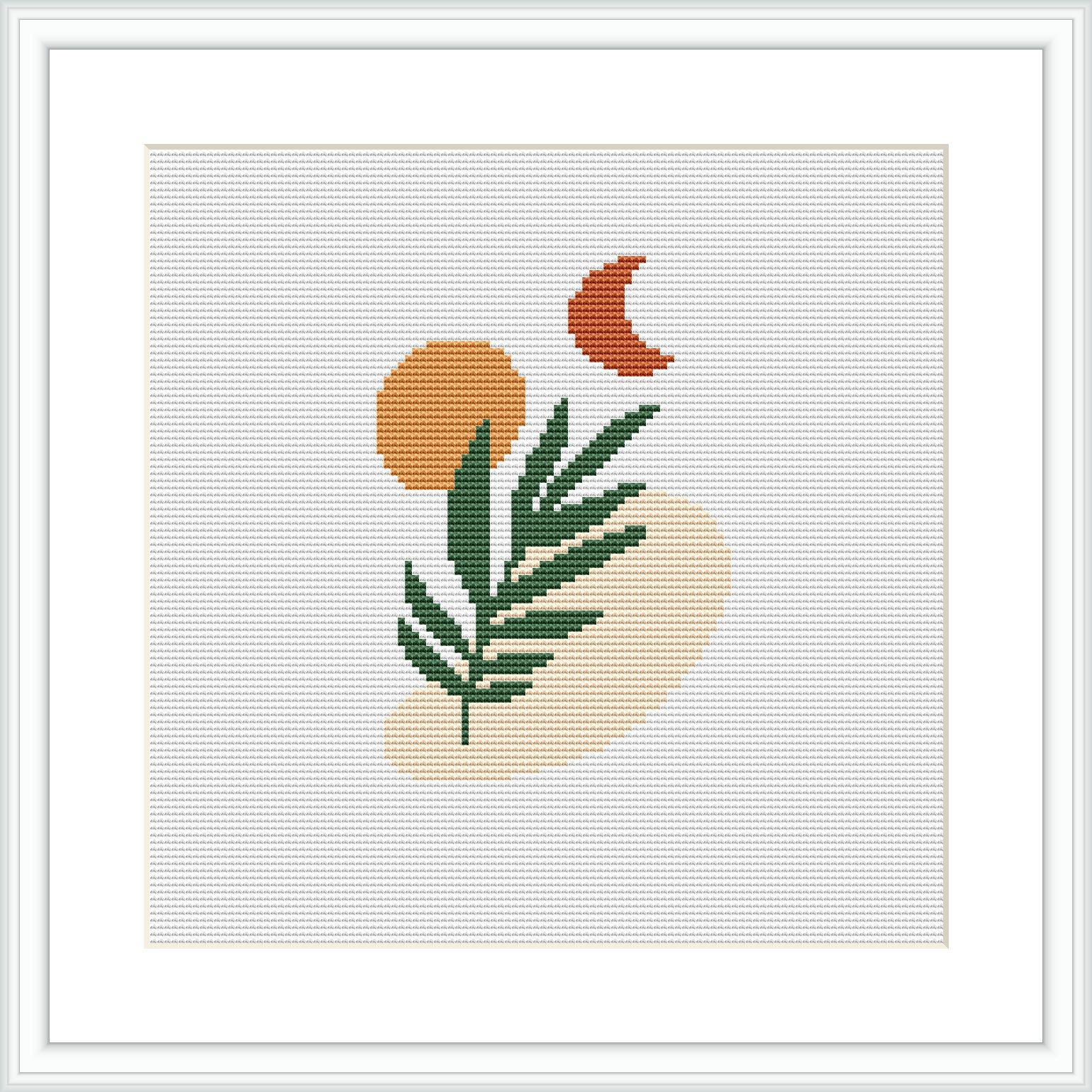 The cross stitch pattern features a minimalist botanical design with a leafy green branch, an orange circle, and a smaller terra-cotta crescent shape, all situated against a cream-colored background within a beige-colored oval.