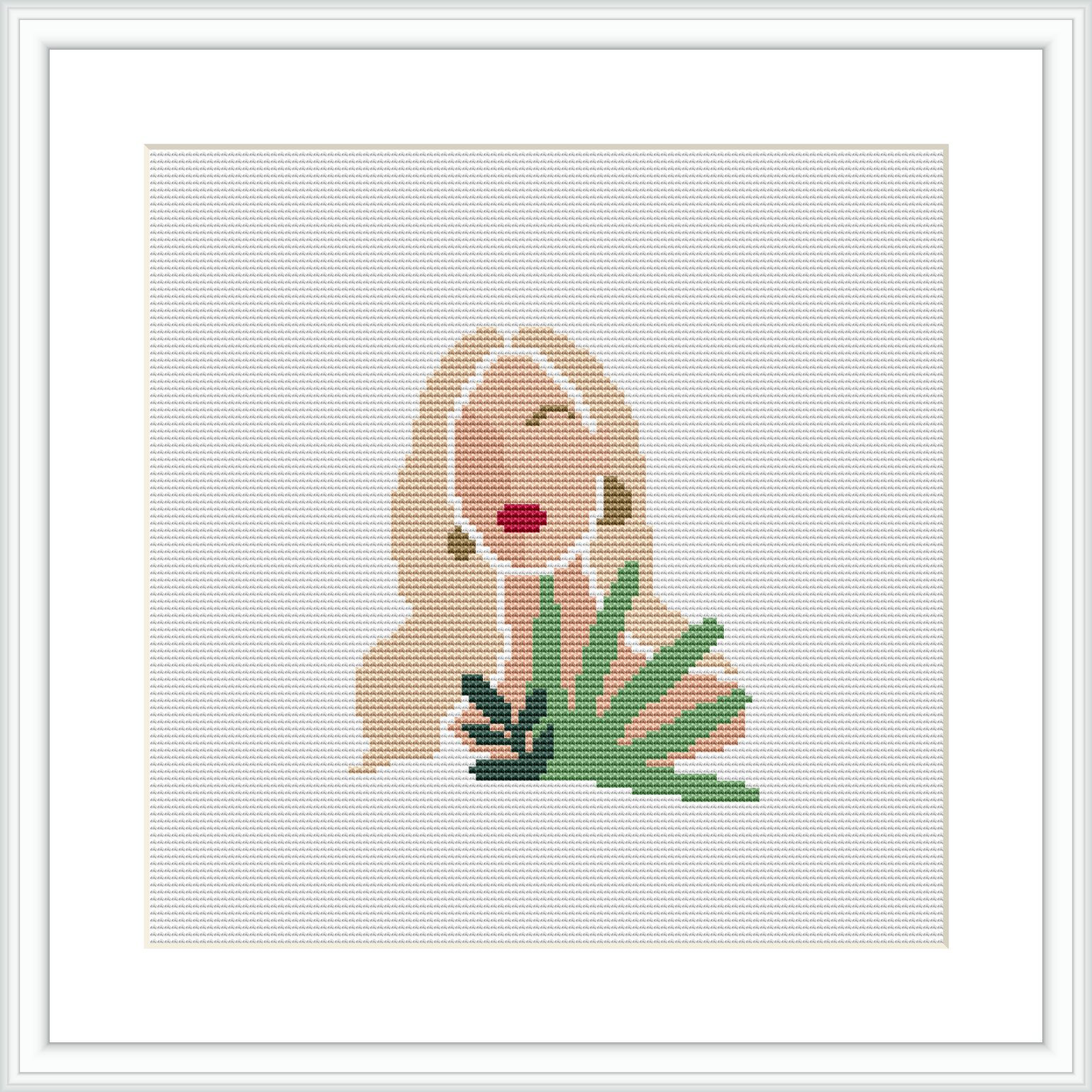 The image depicts a minimalist style cross stitch pattern of a woman with flowing hair and a red lip detail, positioned beside green foliage. The design is displayed within a white frame, placed against a white background.