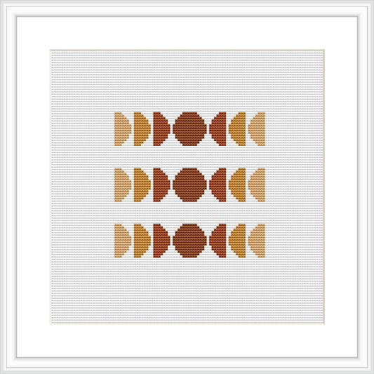 The image displays a framed cross stitch pattern featuring three rows of abstract geometric shapes, symmetrically arranged. The color palette used is subdued with shades of brown, tan, and cream. The design is centered within the frame on a white background.