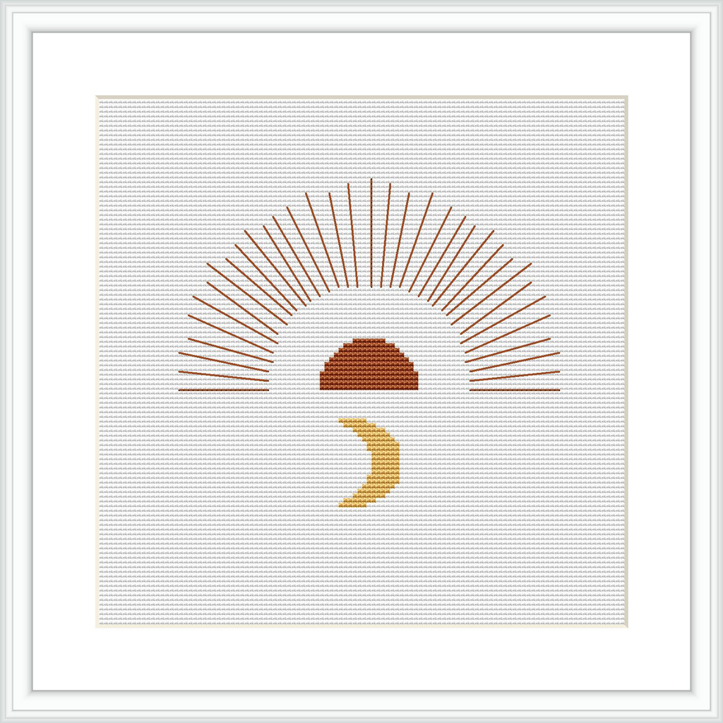 The cross stitch pattern depicts a stylized sunrise, featuring a half-circle in terracotta and beige with linear rays extending upwards. Beneath it, a small crescent moon motif in gold adds a charming contrast, all presented on a white background within a simple frame.