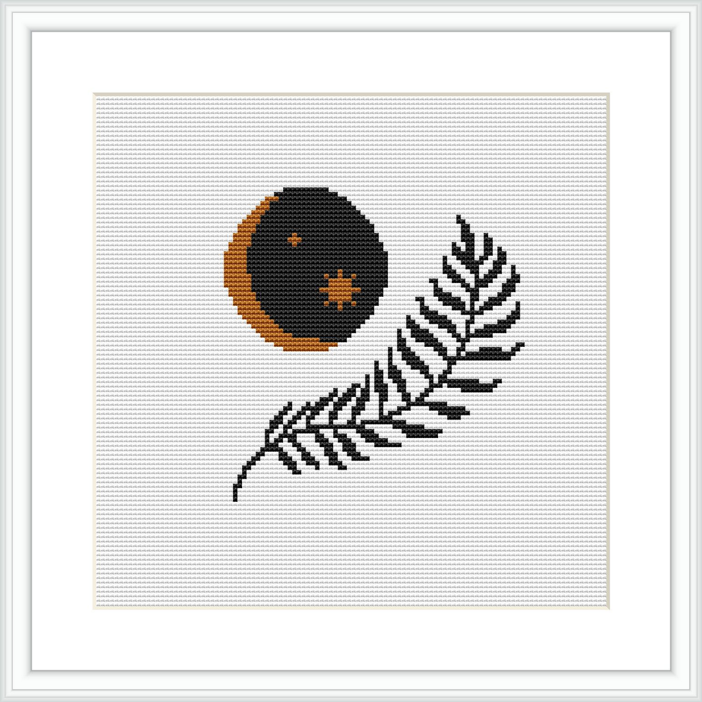 The image displays a framed cross stitch pattern featuring a crescent moon in shades of orange and brown, with small stars, and a black fern leaf below it on a white background.