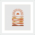 The cross stitch pattern depicts an abstract desert scene with a stylized sun above layered hills or sand dunes, arranged in a geometric gradient style.