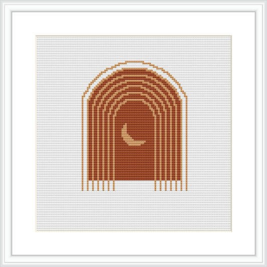 The image depicts a cross stitch pattern framed in white, with a symmetrical arched design centered in warm-toned colors, on a clean white background.