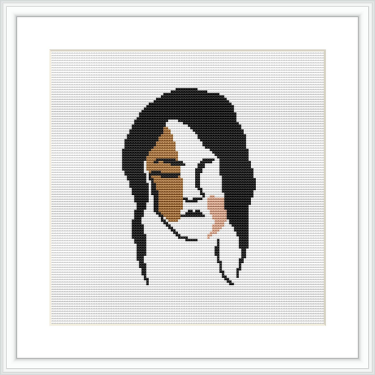 The cross-stitch pattern depicts a stylized, abstract female face with a fragmented and geometric representation, framed and displayed on a clear white background.