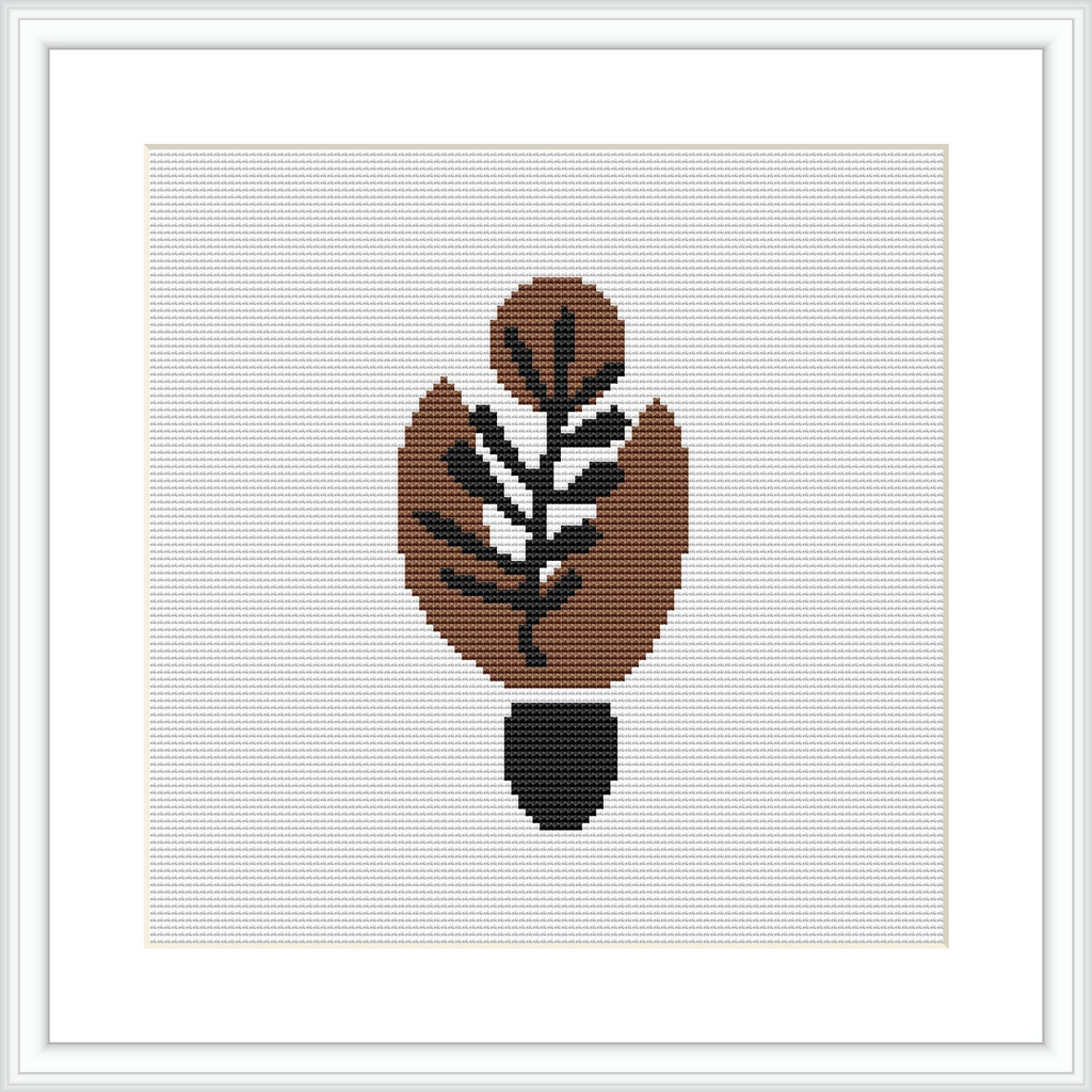 The image shows a framed cross stitch pattern of an abstract leaf design, predominantly in warm brown tones with a black outline, centered on a white canvas background.