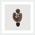 The image shows a framed cross stitch pattern of an abstract leaf design, predominantly in warm brown tones with a black outline, centered on a white canvas background.