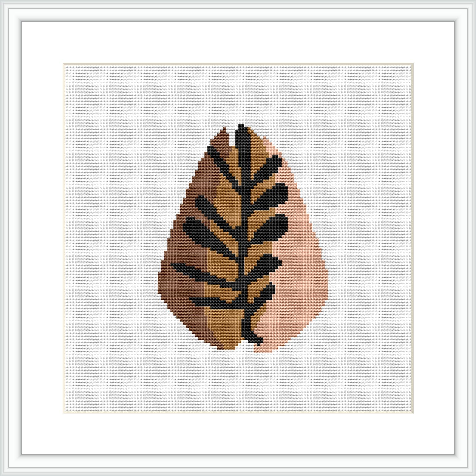 This cross stitch pattern depicts an abstract interpretation of an autumn leaf. The leaf is rendered with pixelated effect, using a warm color palette on a plain, white background.