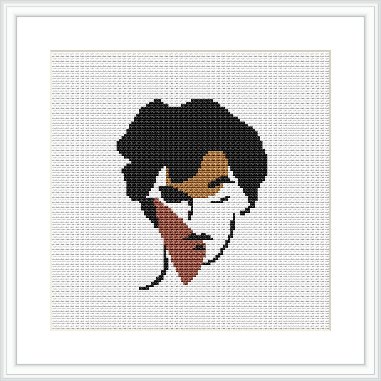 The image shows a framed cross stitch pattern depicting an abstract design of a woman's face. The face is simplified with minimal detail, using broad strokes of color to create contours and shapes.