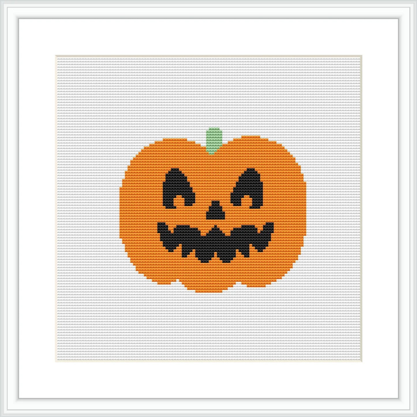 The image features a cross-stitch pattern of a Jack-O'-Lantern with a cartoonish appearance. It has a large smile, triangle eyes, and a small green stalk. The pattern is centered on a grid, framed by a white border, and simulated on an aida fabric background.