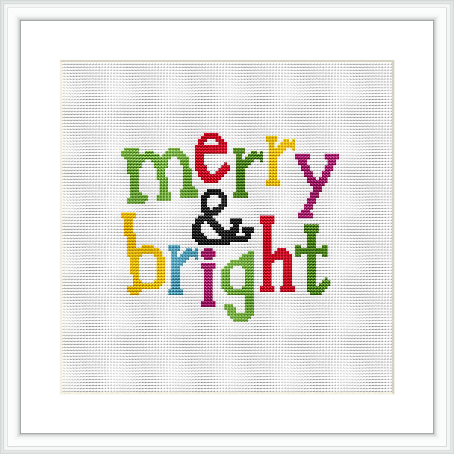 The image displays 'merry & bright' inscribed in colorful block letters, each letter in different bright colors, on a white Aida cloth, framed within a simple square frame.