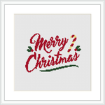 The image features a cross stitch embroidery with the phrase 'Merry Christmas' in cursive, variegated red and green stitching. The text is embellished with sprigs of green holly leaves and red berries. The design is framed within a simple square border, mimicking a picture frame.