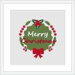 The image displays a cross stitch pattern featuring a circular Christmas wreath with the words 'Merry Christmas' in the center. Holly berries and leaves are dispersed throughout the wreath, and there is a prominent red bow at the bottom.