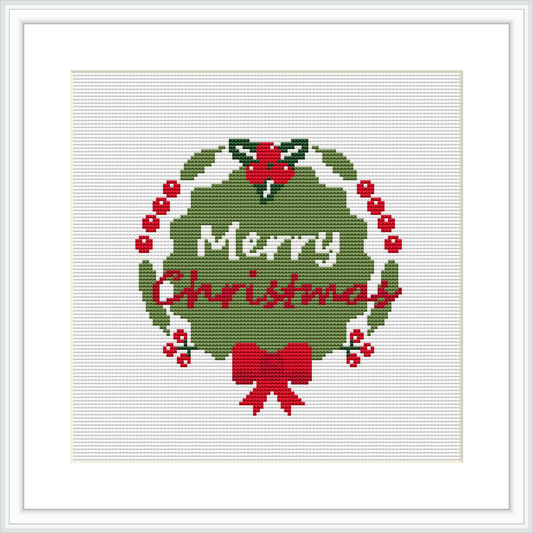 The image displays a cross stitch pattern featuring a circular Christmas wreath with the words 'Merry Christmas' in the center. Holly berries and leaves are dispersed throughout the wreath, and there is a prominent red bow at the bottom.