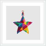 The image showcases a cross stitch pattern of a stylized Christmas star, composed of geometric shapes filled with various vibrant colors. This star is centered on a white canvas, framed with a simple white border. The general composition is flat with a pixelated texture representative of cross stitch technique.