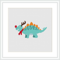 The image depicts a cross-stitch pattern of a green dinosaur with a red scarf and what appears to be reindeer antlers, embellished with decorative Christmas-themed patterns.