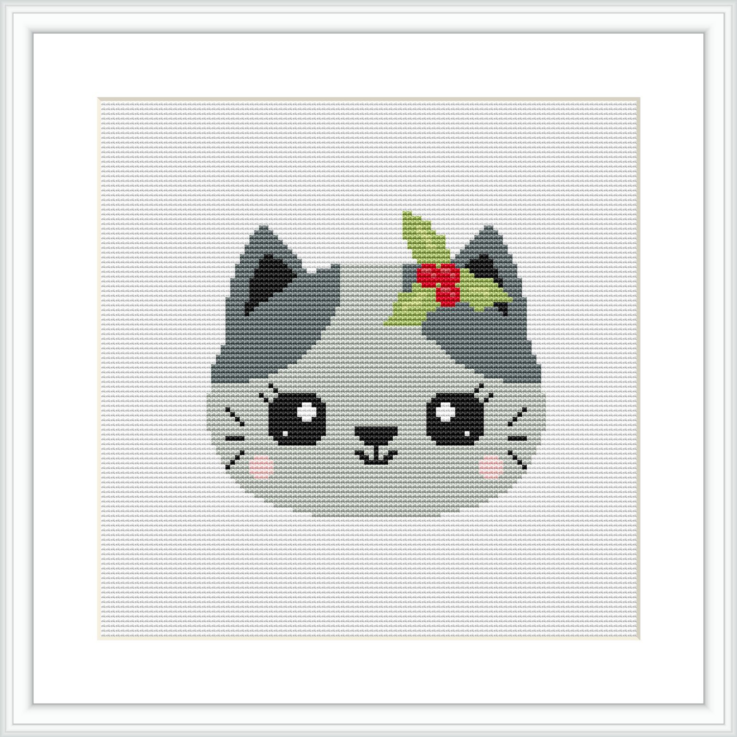 This cross stitch pattern depicts a grey cat with big, round eyes and prominent whiskers. The cat is accessorized with a small, red and green holly plant atop its head.