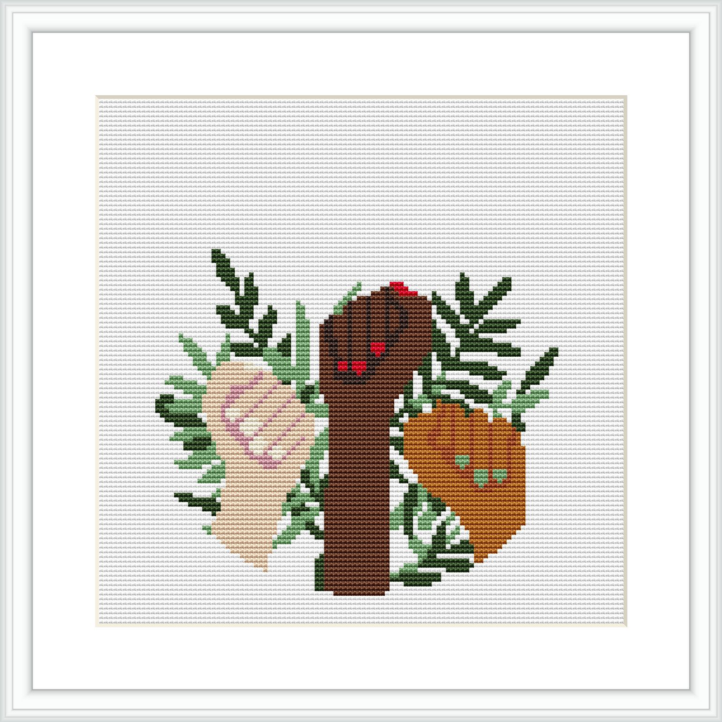The image depicts a cross stitch pattern showcasing an arrangement of various leaf shapes in different shades of green. A stylized branch in brown extends through the design with a red and a beige decorative heart, each with small accent details.