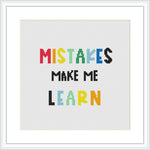 The image shows a framed cross stitch pattern with the phrase 'MISTAKES MAKE ME LEARN' stitched in colorful letters of varying font styles. The pattern is centered on a white aida cloth, presenting a clean and modern aesthetic.