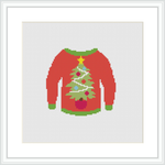 The image shows a cross stitch pattern framed in white, depicting a traditional red ugly Christmas sweater. The sweater is adorned with green cuffs and a green Christmas tree decorated with various ornaments at the center.