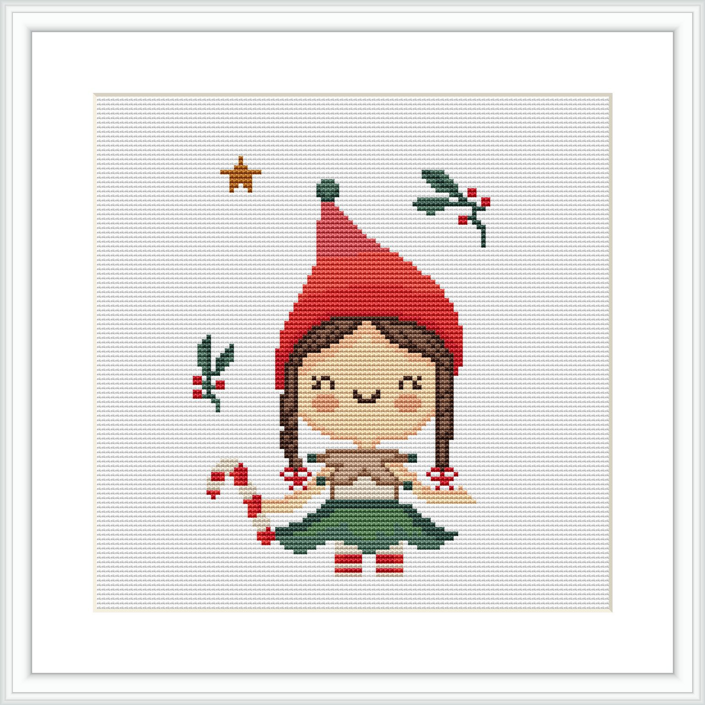 The image depicts a framed cross stitch pattern of an elf girl surrounded by festive elements such as holly leaves and a star, against a white background.