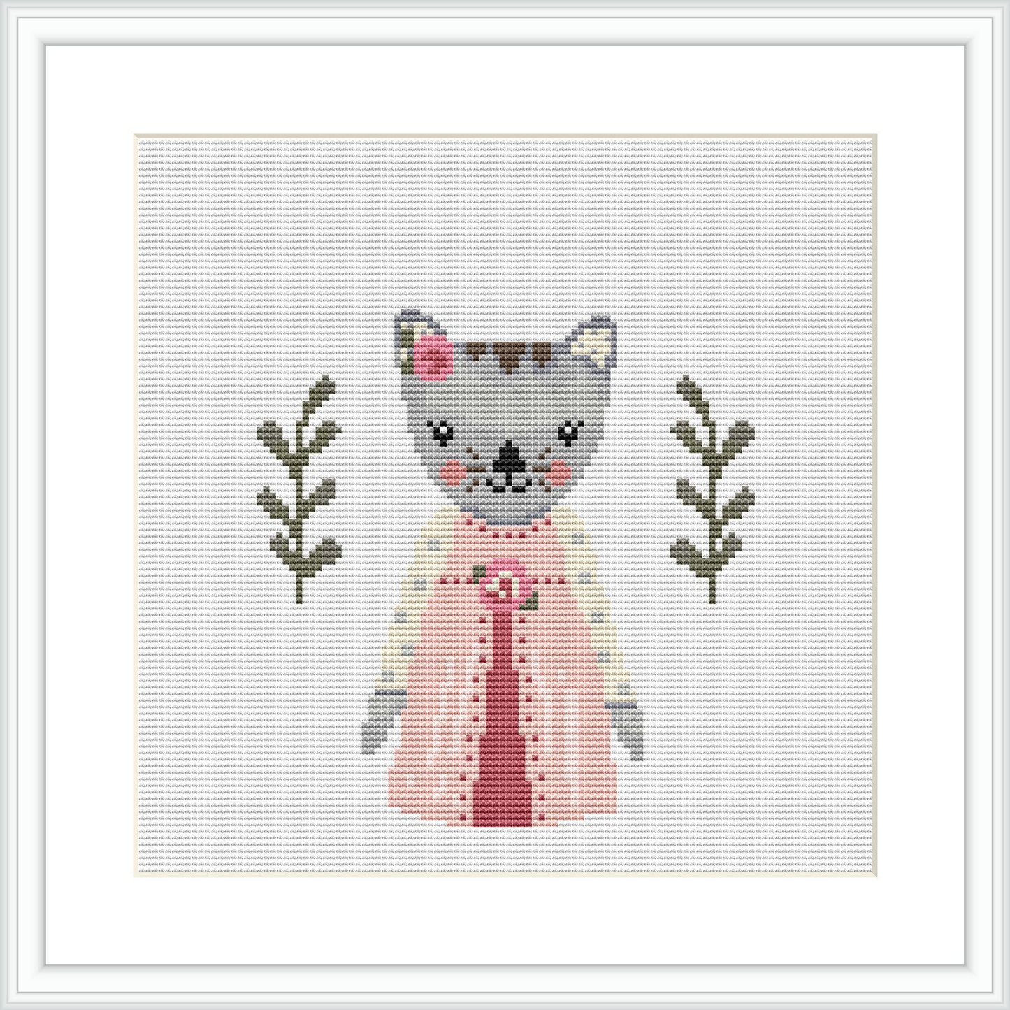 The image displays a cross stitch pattern design of a grey and white cat wearing a pink dress with a white apron. The cat is flanked by two olive green branches with leaves, set against a plain white background.