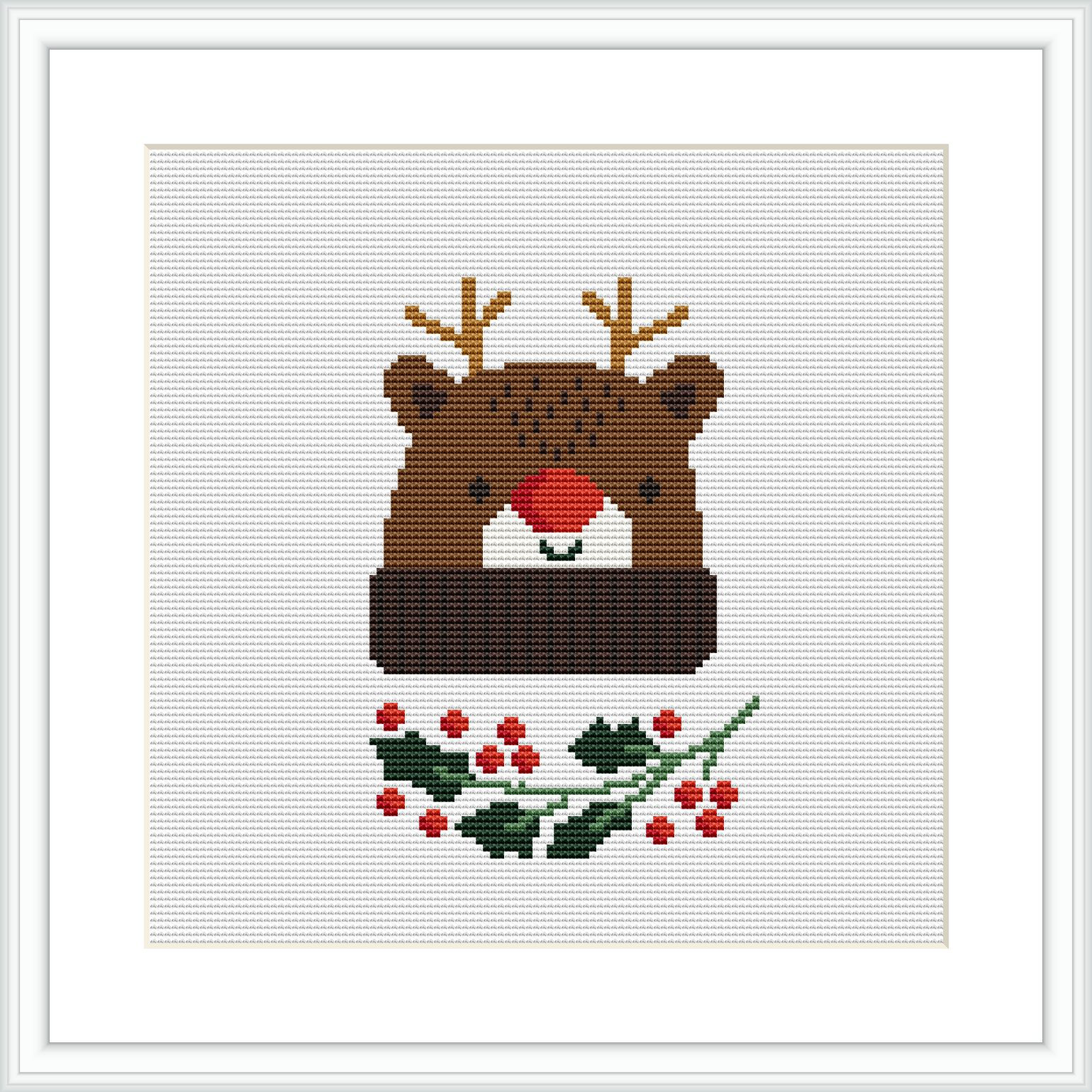 The image features a framed cross stitch pattern of a bear wearing a Christmas hat. The bear is centered on the canvas, surrounded by holly leaves and berries at the bottom. The pattern uses a variety of colors mainly focusing on browns, greens, and reds.