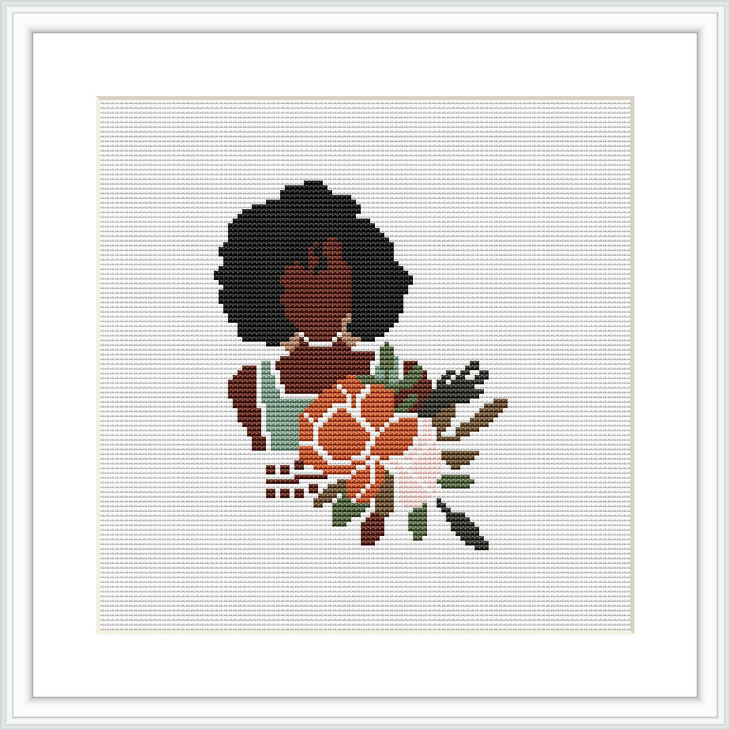 The image depicts a cross stitch pattern of a stylized woman with dark curly hair, wearing an orange and brown dress with a floral pattern. She is holding a bouquet of flowers and leaves, centered against a white background within a square frame.