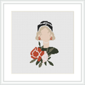 The cross stitch pattern depicts a stylized woman's portrait with large flowers, possibly roses, set against a plain white background in a square frame.