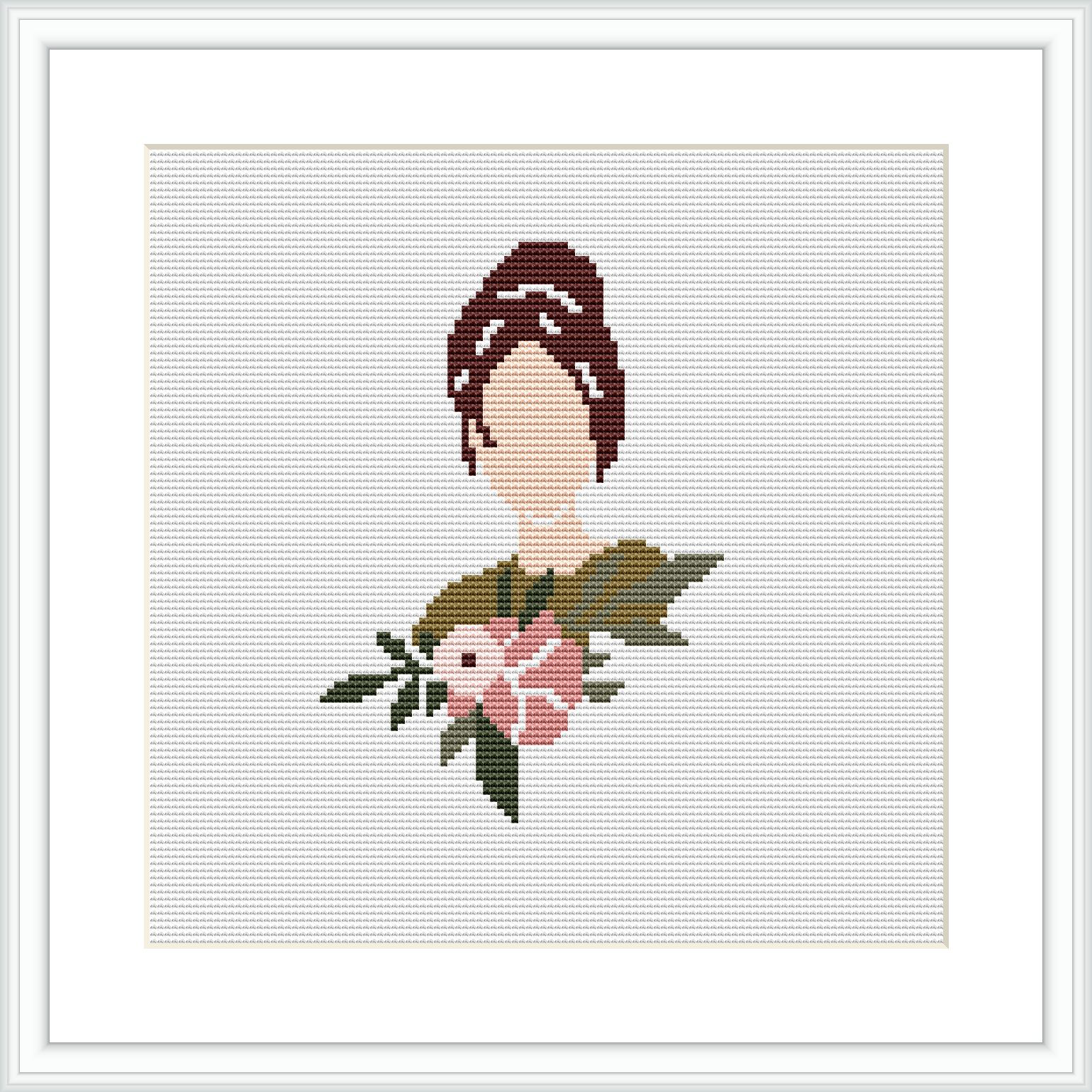 The image displays a framed cross stitch pattern depicting the upper torso of a stylized woman adorned with a floral arrangement. The pattern has a white background and is mounted within a simple, elegant frame.
